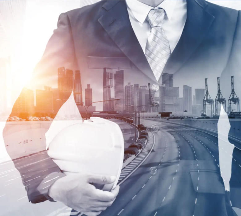 Businessman holding helmet, cityscape background overlay.