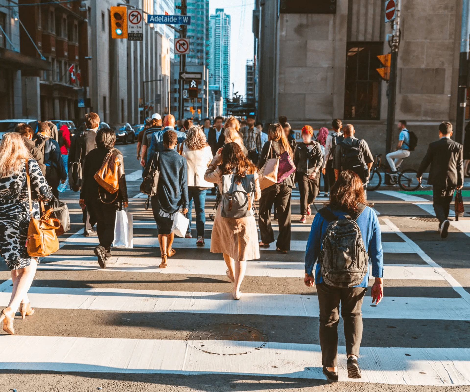 People crossing a busy city street.